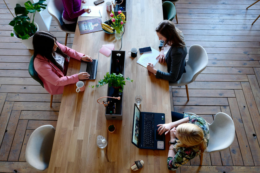 people working at coffee shop table