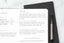 a fitness journal with smart fitness goals written in it, lying on top of another journal on a white table
