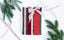 A wrapped gift sits on a white table, surrounded by evergreen boughs and candy canes