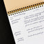 A meeting notes pad with handwritten board meeting notes