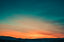 A sunrise over a low mountain range