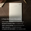 Notebook with lined pages on a textured surface, accompanied by promotional text.