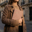 Woman holding a daily reflection journal