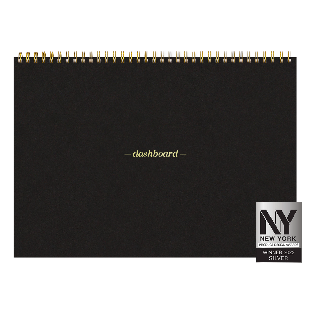 Black spiral-bound notebook with 'dashboard' branding and a New York Product Design Award badge.